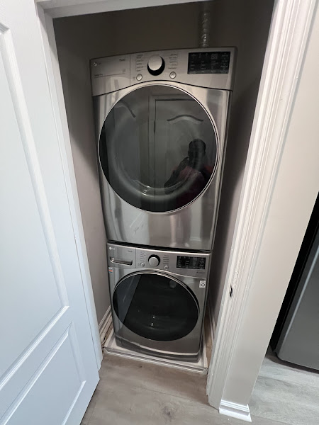 Stacked LG washer and dryer unit serviced by Appliance Solutions - dryer vent cleaning and drum belt replacement